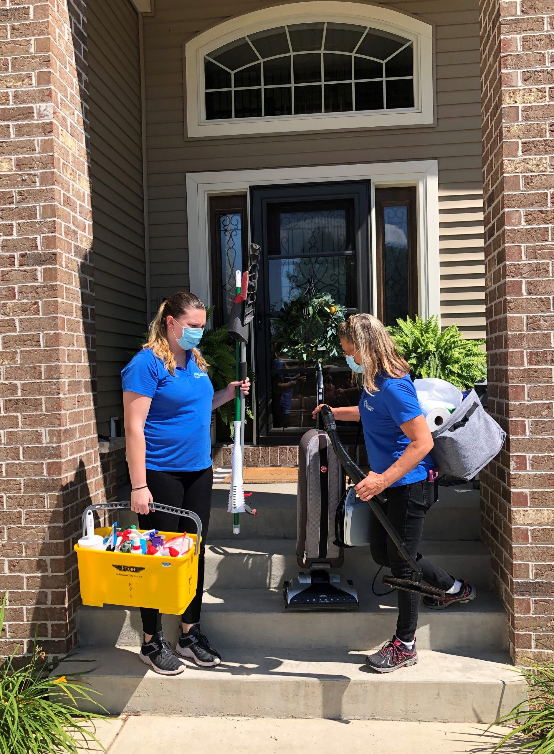 Professional cleaning team arriving at a house